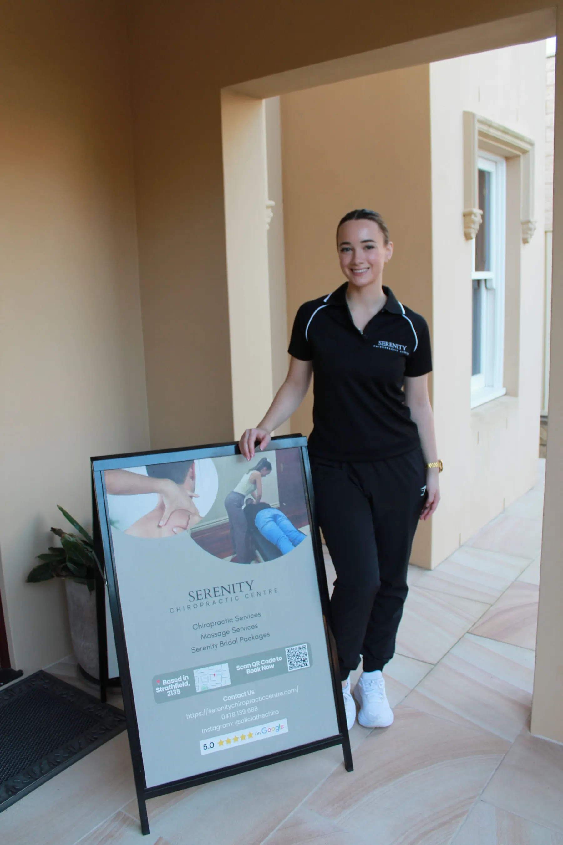 Alicia Neil at the clinic entrance on Agnes Street beside the Serenity sign